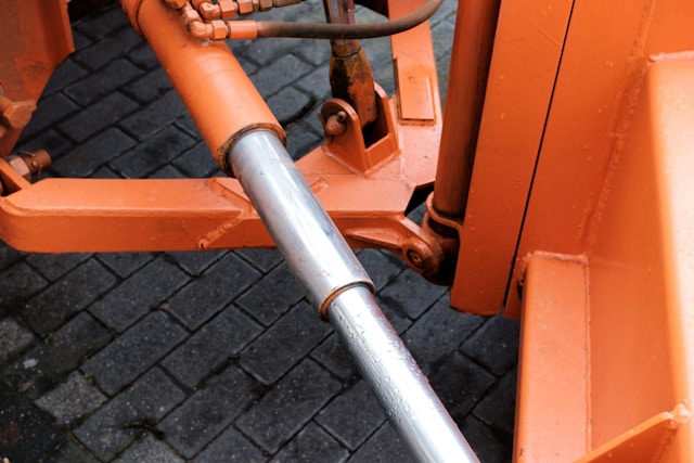 Downward Shot of Hydraulic Cylinder on Orange Machine